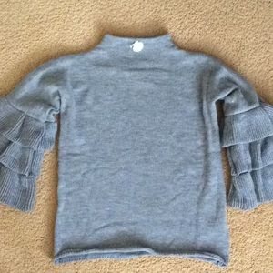 Grey heather sweater with detailed sleeves. Acrylic, one size fits most